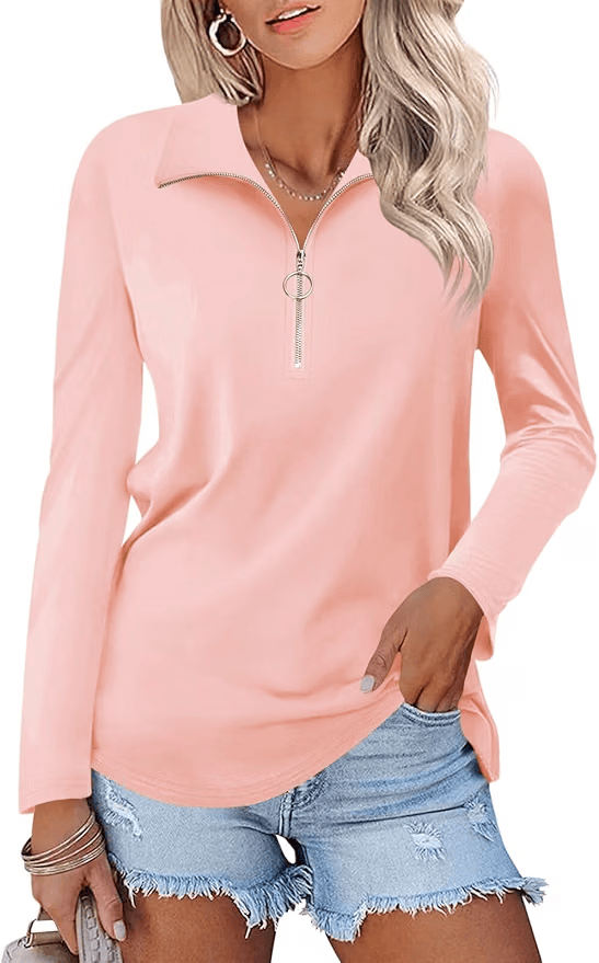 Model wearing a light pink zip-up long sleeve shirt with a collar, paired with distressed denim shorts.